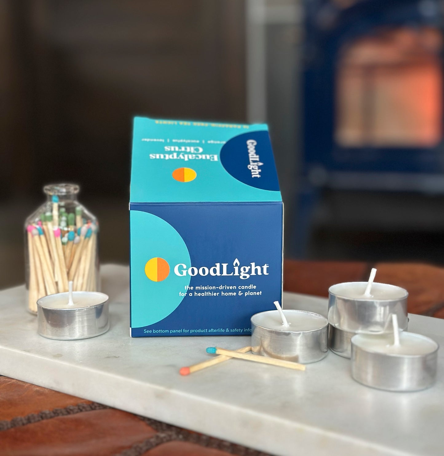 GoodLight Eucalyptus Citrus scented candles and packaging on a surface with matches in the background