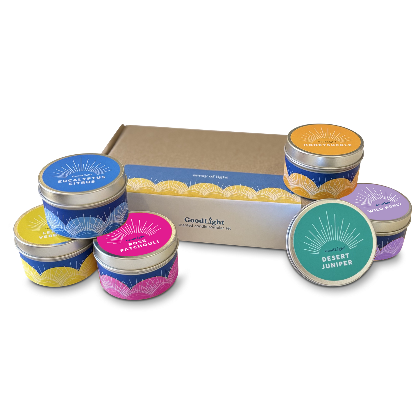 Collection of small candles in colorful tins with a GoodLight cardboard box on a white background.