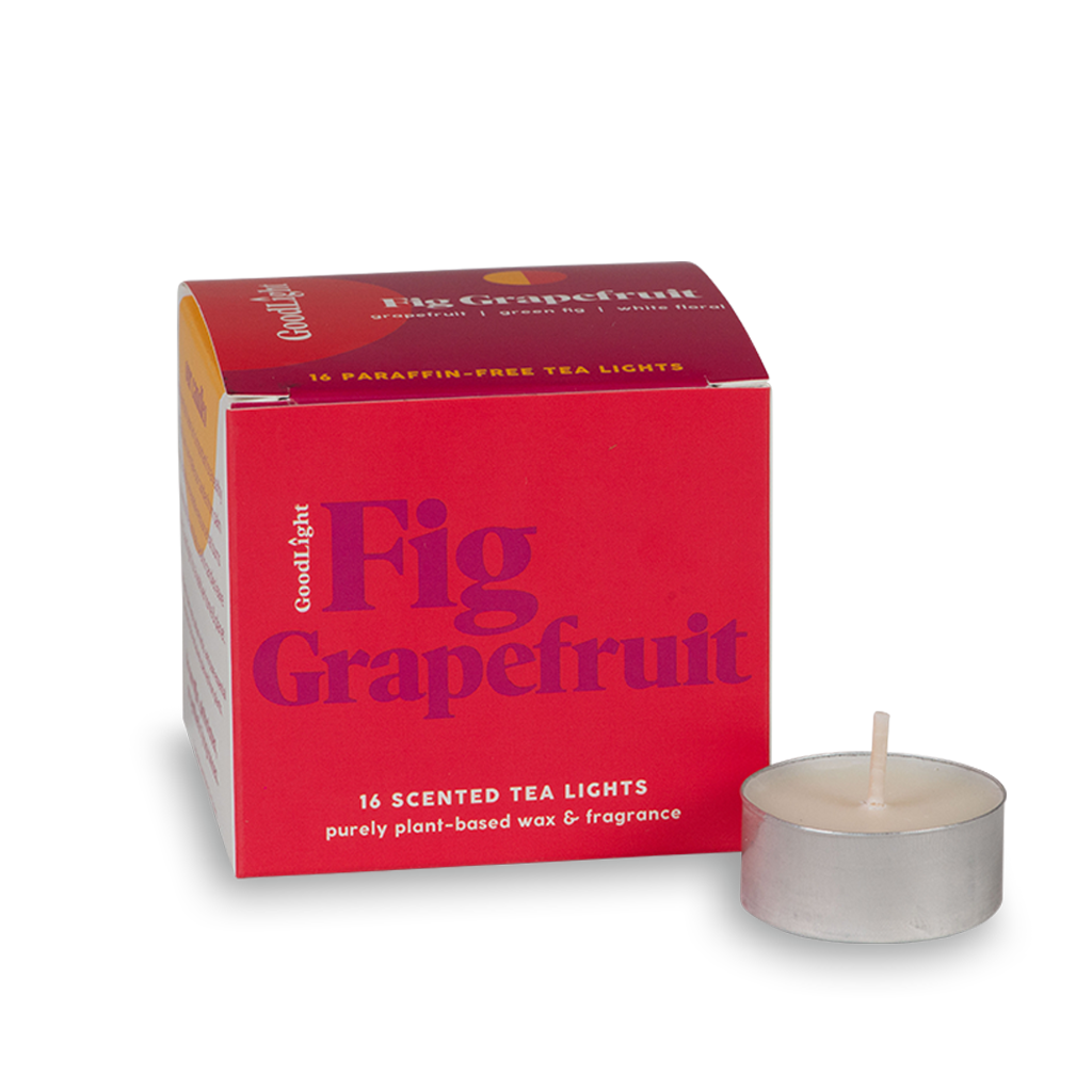 Red box of GoodLight Fig Grapefruit scented tea lights with a single candle on a white background