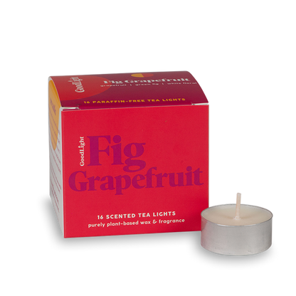 Red box of GoodLight Fig Grapefruit scented tea lights with a single candle on a white background