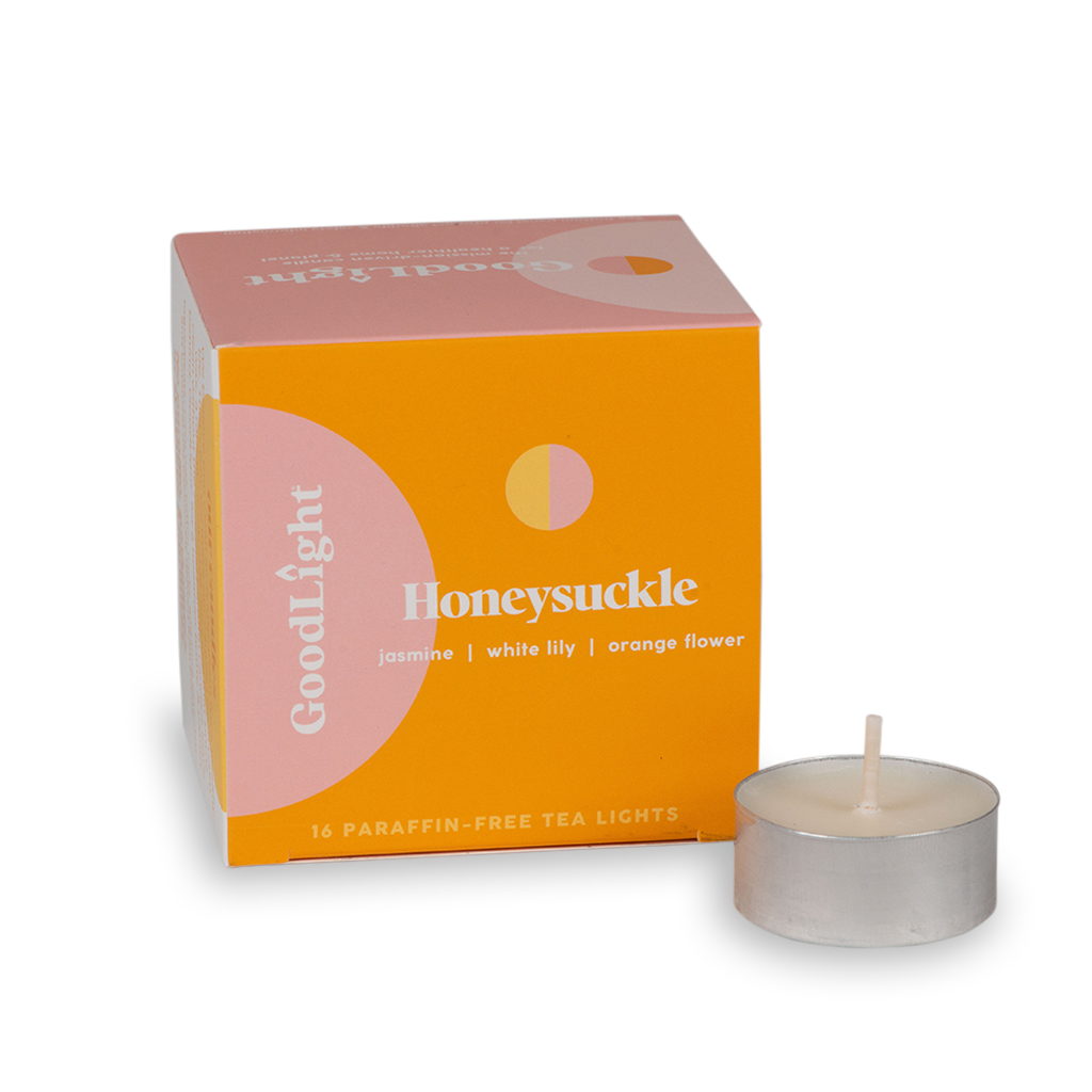 Honeysuckle tea light candle with GoodLight packaging on a white background