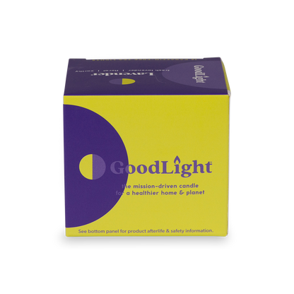 Purple and yellow GoodLight candle packaging on a white background
