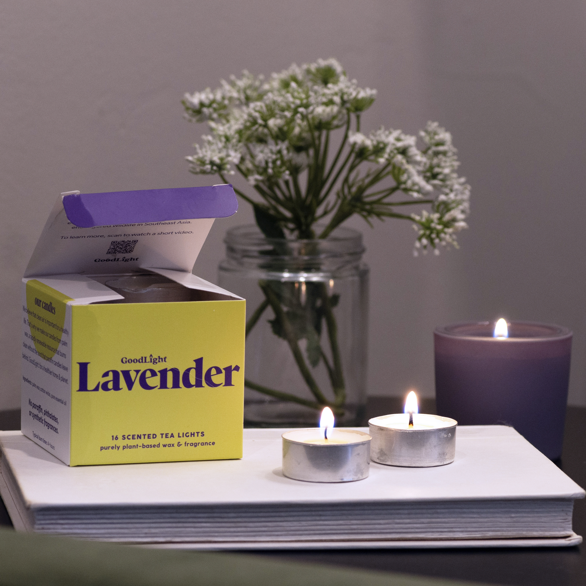 Goodnight Lavender scented tea lights with packaging and a candle on a surface.