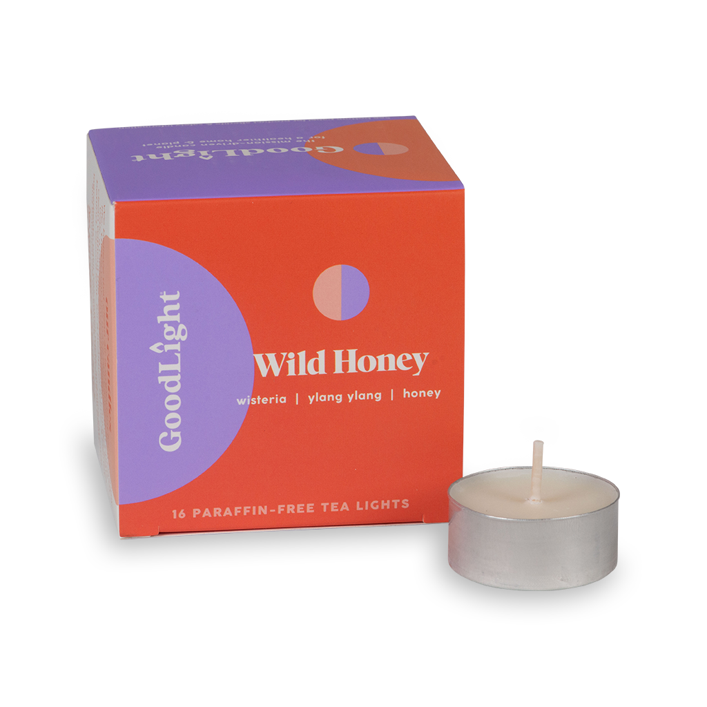 Tea light candle and GoodLight packaging with 'Wild Honey' branding on a white background