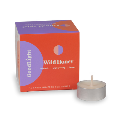Tea light candle and GoodLight packaging with 'Wild Honey' branding on a white background