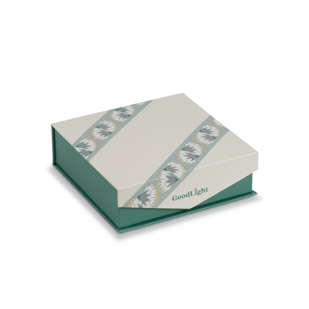 A GoodLight branded square gift box with a cream-colored lid featuring two diagonal patterned bands and a teal-green base, shown on a plain white background.