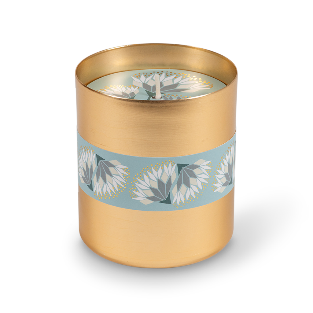 A cylindrical gold metal tumbler featuring a decorative light blue band wrapped around the middle with white and gray floral motifs.