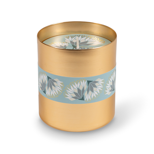 A cylindrical gold metal tumbler featuring a decorative light blue band wrapped around the middle with white and gray floral motifs.